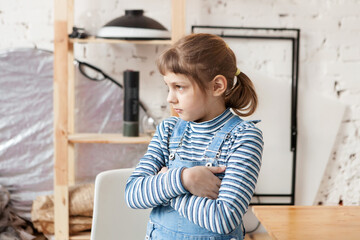  Sad girl of 8 years old  crossing   arms over   chest