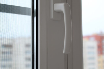 closed plastic window and handle for opening the window