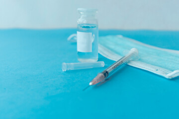 Vaccine in vial and syringe close-up on a white table gray background, medical concept, laboratory, subcutaneous injection vaccination, dose. Disease treatment immunization