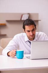 Young male employee working from home during pandemic