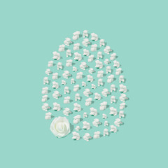 Easter composition made of white easter bunnies and rose flower in egg shape. Minimal holiday concept