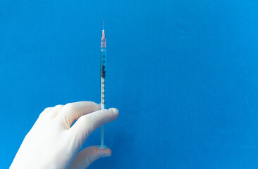 Vaccine in vial and syringe close-up on a white table gray background, medical concept, laboratory, subcutaneous injection vaccination, dose. Disease treatment immunization