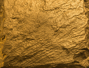 Gold texture. Rough structure mineral. Rock texture. Gold Ore. Gold rocks. Stone background.