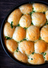homemade buns with garlic and parsley in a pan
