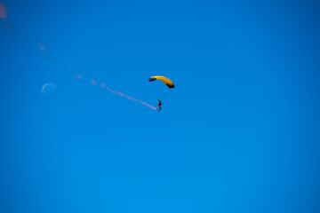 Parachutist on the background of blue sky