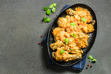 Homemade rustic chicken stew in cast iron skillet. Space for text, top view.