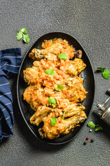 Healthy paleo chicken stew in cast iron skillet. Space for text, top view.