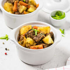 Delicious traditional  roast pork and potatoes in pots. Copy space.