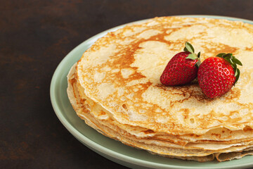 Pancake on the green plate. Many pancakes are stacked