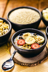 vegan dessert of quinoa, banana, Strawberry, nuts and cinnamon in the background. Vegetarian breakfast