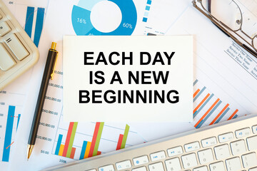 Obraz premium Each day is a new beginning is written in a document on the office desk, diagram and keyboard