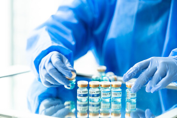 Medical concept ampoules or vials with Covid-19 vaccine on a laboratory bench