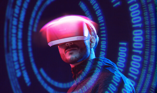 Man on dark virtual reality background. Guy using VR helmet. Augmented reality, future technology, game concept. Blue neon light. Futuristic holographic interface to display data.