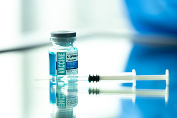 Medical concept ampoules or vials with Covid-19 vaccine on a laboratory bench