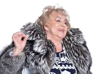Senior woman in  fur coat  posing