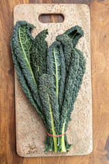 Cooking with black flat leaves of cavolo nero tuscan cabbage