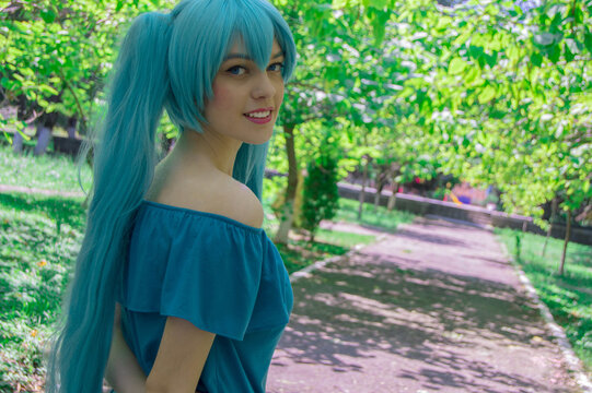 Russian anime cosplay portrait of a girl  in garden. Hatsune Miku cosplay
