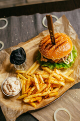 burger on a plate with french fries and sauce