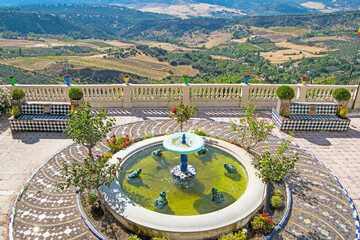Fountain with views of the Sierra de las Nieves Natural Park from the Genal Valley. Serrania de Ronda, Andalusia, Spain
