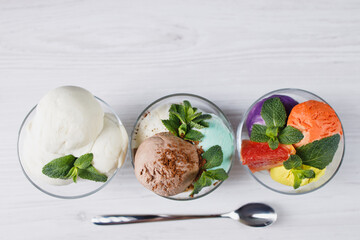 Ice-cream. Flavored sundae and fruit sorbet variety in glass bowls, refreshing dessert for summertime. Tasty homemade food, natural sweets