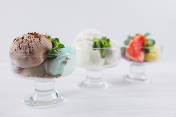 Ice-cream. Flavored sundae scoops variety in glass bowls, refreshing dessert for summertime. Tasty homemade food, natural sweets