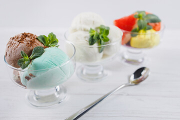 Ice-cream. Flavored sundae variety in glass bowls, refreshing dessert for summertime. Tasty homemade food, natural sweets