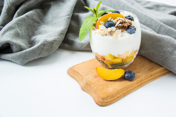Healthy blueberry and walnut parfait in a glass on a white background