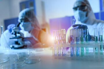 Doctor in the laboratory analyzes samples under a microscope. Pharmaceutical treatment concept.