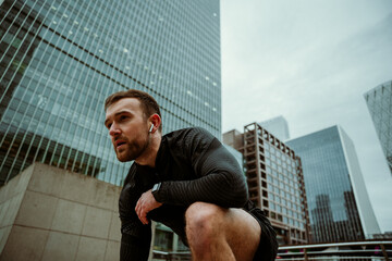 Caucasian male athlete preparing to run while training fitness in city