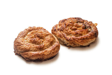 Two puff pastry pies with minced meat, with a golden crust on a white background