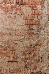 Stone wall with exposed bricks, red, cracked and damaged brick wall, background for template