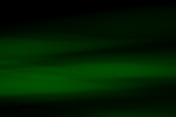 Obraz premium Green abstract background - lines and streaks of light. Blurred, irregular light elements on black background. Green fanciful 3d patterns.