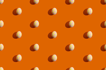 Easter pattern. Traditional seamless banner. Holiday decoration. Abstract background. Yellow eggs with pink spotted ornament isolated on orange.
