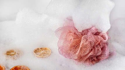 Purple washcloth and white foam all around. Abstract background