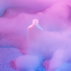 White shampoo bottle in colorful foam. Abstract square background