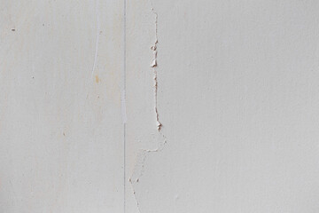 Abstract texture of a rough wall with torn wallpaper. Repair Texture
