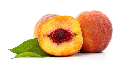 Sliced peach with bone and green leaves.