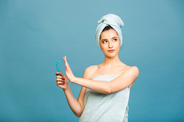 Displeased angry woman against of shaving, holds razor in hand, supports wax depilation, poses half...
