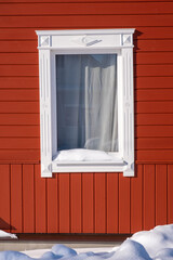 Carved white wooden trim on the background of the red wall.