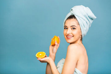 Beauty portrait of joyful attractive half naked woman with towel wrapped around her face, holding...