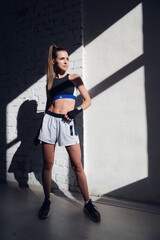 Naklejka premium Close up of one young woman wrapping hands with black boxing wraps in gym practice boxing indoor working out fitness female lifestyle