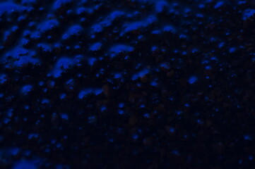 Abstract blue mysterious background. Rough texture in dark light. Oily, oily ooze with bubbles and lumps. Dark uneven background with reflected blue light. 3d illustration with gestural texture. © Adam Bialek