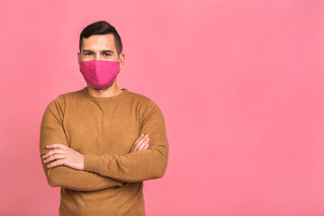 Fototapeta premium Protection against contagious disease, coronavirus, covid-19. Man wearing hygienic mask to prevent infection, airborne respiratory illness such as flu, 2019-nCoV. Isolated over pink background