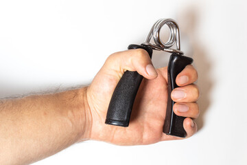 Hand holding a black hand grip plastic and metal on a white background surface