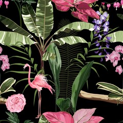 Pink flamingo and exotic flowers, palm leaves on black background. Floral seamless pattern. Tropical illustration. Exotic plants, birds. Summer beach design. Paradise nature.