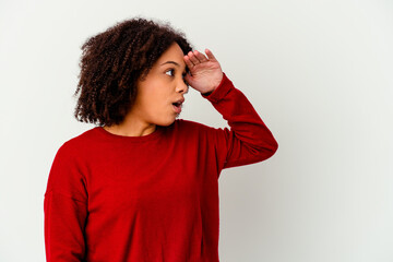 Young african american mixed race woman isolated looking far away keeping hand on forehead.