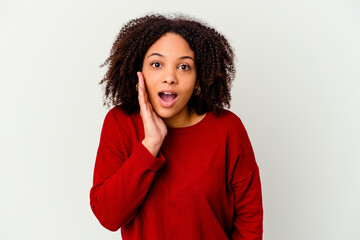 Young african american mixed race woman isolated shouts loud, keeps eyes opened and hands tense.