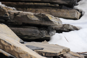 Snow on Large Slate Rocks and Stones