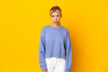 Young Russian woman isolated on yellow background with sad expression