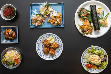 small portions of Japanese food over the table from above